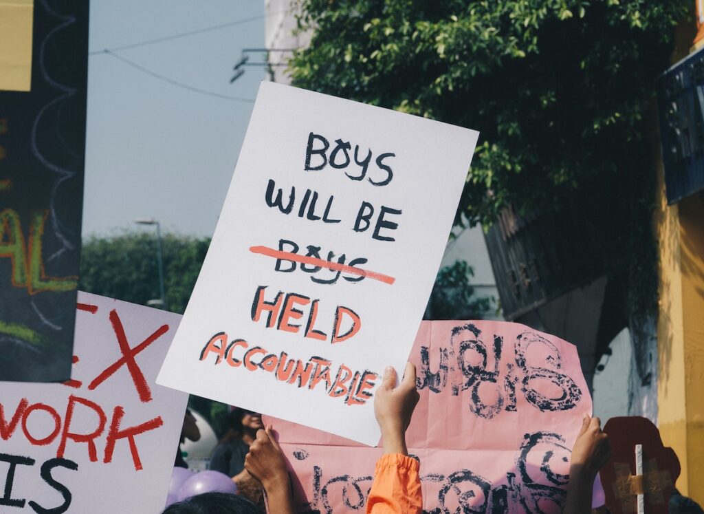 protest sign: boys will be held accountable