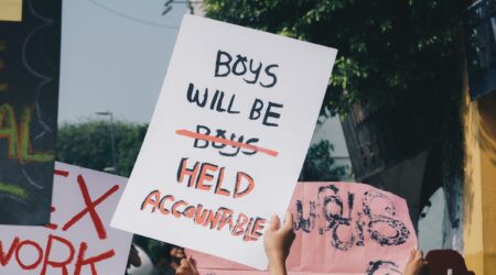 protest sign: boys will be held accountable