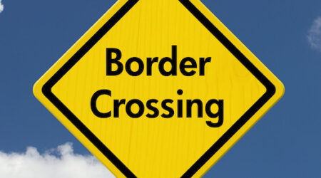 yellow border crossing sign