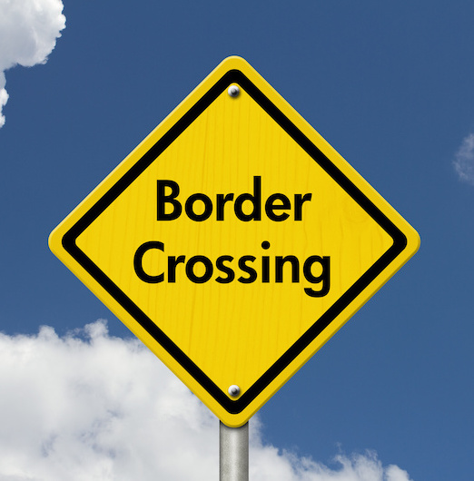 yellow border crossing sign