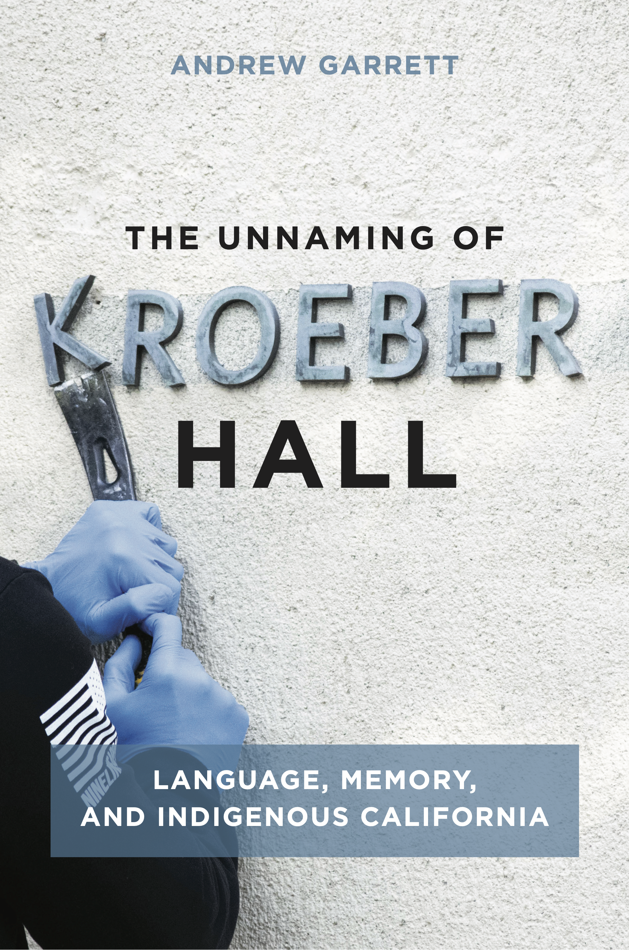 Book cover - a person prying the K off the wall of a building