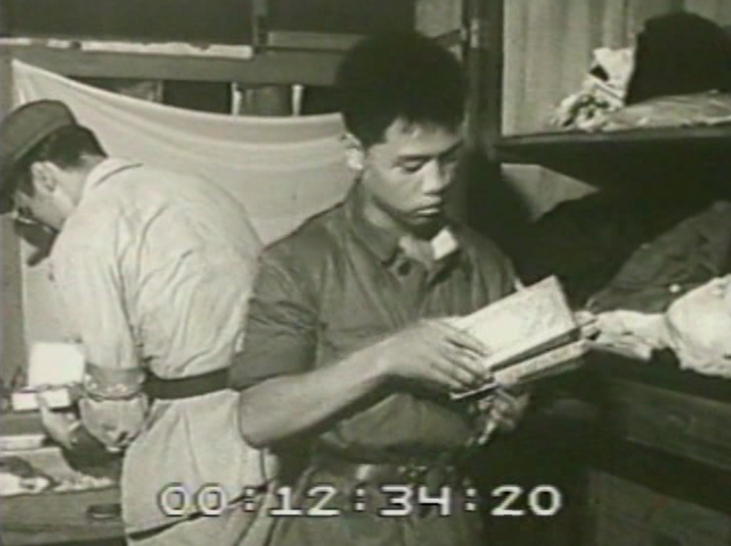 Two men rummaging through property in a person's house.