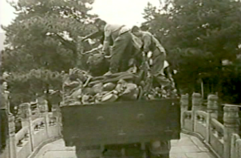 A group of men on the back of a truck with confiscated property.